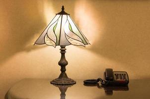 table lamp and phone on desk photo