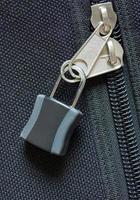 zipper locked on black canvas bag photo