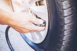 Technician is repairing car flat tire photo