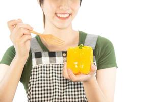 Happy lady holding kichen stuff over copy space background - people home made food preparation concept photo