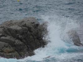 Rough sea, waves crashing against the rocks photo