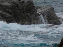 Rough sea, waves crashing against the rocks photo