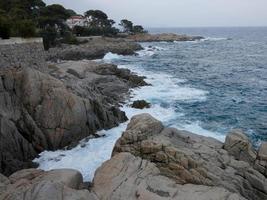 mar agitado, olas rompiendo contra las rocas foto