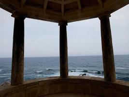 Classic stone traffic circle with sea background located on the Catalan Costa Brava, Spain. photo