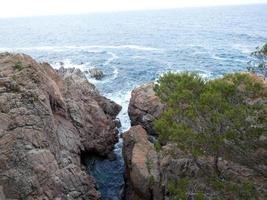 Rough sea, waves crashing against the rocks photo