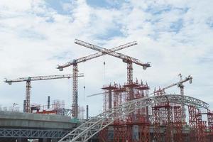 Tower cranes in construction site photo