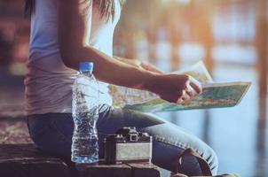 Tourist travel woman looking at the map while walking at train station  - street backpack travel concept photo