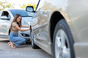 Women drivers sad after a car accident because not have car accident insurance. photo