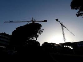 Crane at work on a building site transporting materials photo