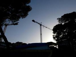 Crane at work on a building site transporting materials photo