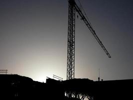 Crane at work on a building site transporting materials photo