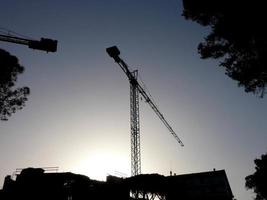 Crane at work on a building site transporting materials photo