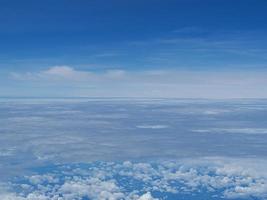 Aerial view of cloudscape seen through airplane window photo