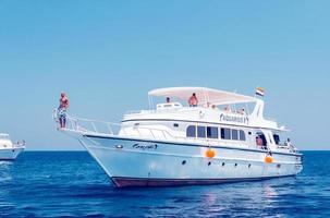 Hurghada, Egypt. August 3, 2014 - White ship with divers moored near a coral reef photo