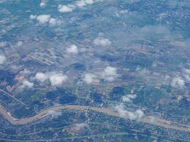 Aerial view of agricultural field and river seen through airplane window photo