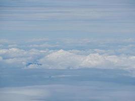 Aerial view of cloudscape seen through airplane window photo