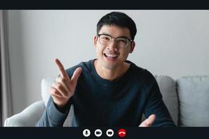 Portrait happy man working at home by video conference meeting talking and looking at camera. greeting family or friends photo