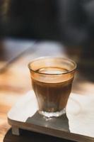 A glass of espresso shot over cold fresh milk. Dirty Coffee, Coffee menu, Milk Coffee photo