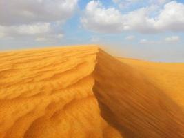 Sand dunes in the desert photo