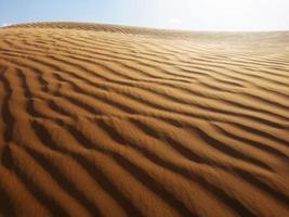 Sand dunes in the desert photo