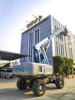 Jakarta, Indonesia, June 18th 2022. Manlift crane with platform lifting to the roof top of a building photo