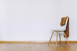 Indoors flat wall mockup with Clothes on Chair photo