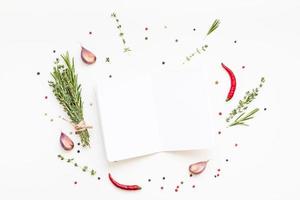 Blank notepad pages with greens herbs and spices photo