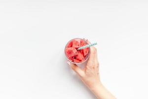 Woman hands with crushed watermelon in glass photo
