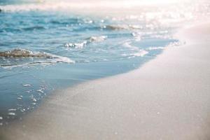 Summer sand beach and seashore waves background photo