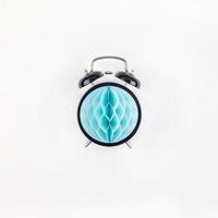 Black alarm clock with blue paper ball concept photo