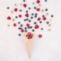 Summer composition berries ice cream waffle cone photo