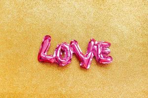 Love concept. Inflatable pink balloon with letters photo