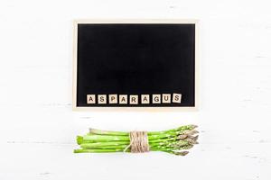 Fresh green asparagus with black chalkboard frame photo