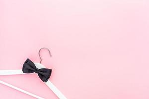 White hangers on pastel pink background photo