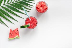 Watermelon smoothie with crushed fruits in glasses photo