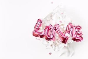 Love concept. Inflatable pink balloon with letters photo