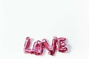 Love concept. Inflatable pink balloon with letters photo