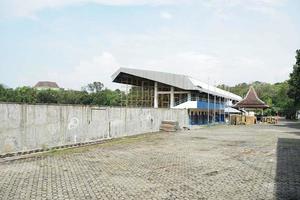 SOLO, INDONESIA , 2022 - sports field stadium renovation with plug and wall photo