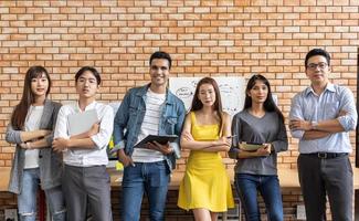 Portrait of Asian creative business team. Hipster Creative Startup Young business people in modern office. photo