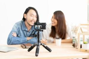 Young Asian couple blogger with recording video. photo