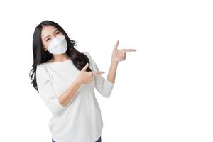 Young Asian woman wearing hygienic mask to prevent infection corona virus Air pollution pm2.5 in isolated on white background photo