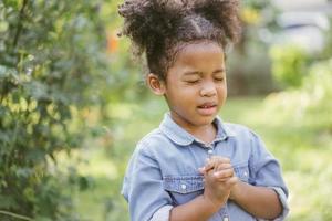 little girl praying. kid prays. photo