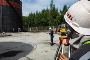 Male worker inspection    survey  level tank photo