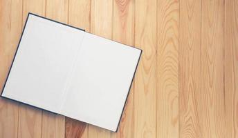 open notebook on brown wooden table photo