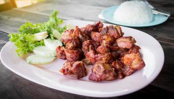 juicy fried pork ribs on plate photo