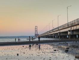 Surabaya, Jawa timur, Indonesia, 2022 - The view of the Suramadu Bridge seen from below in the afternoon photo