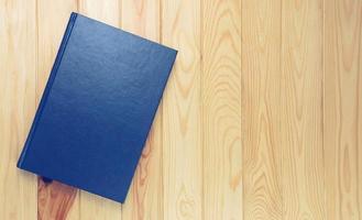 dark blue book on brown wooden table photo