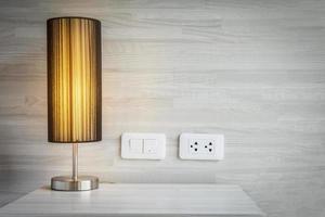 Yellow light decoration in bed room with switch and electric plug connector - bed room background concept photo