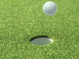 Golf ball floating in the air on a golf course photo