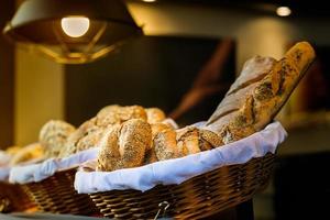 Bread and buns inside wicker basket photo